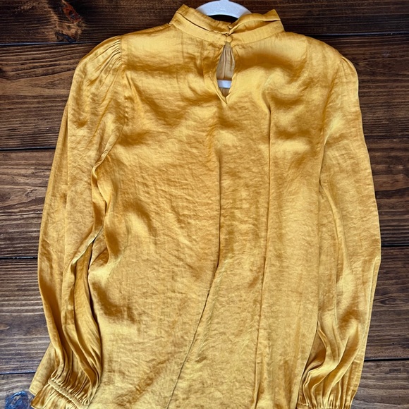 Keyhole w button closure
Mock neck
Long sleeve w gathered shoulders
Polyester - Picture 4 of 5